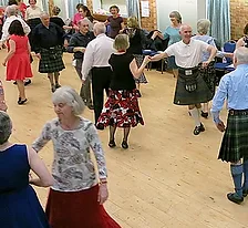 Dancers in kilts at a Scottish country dance