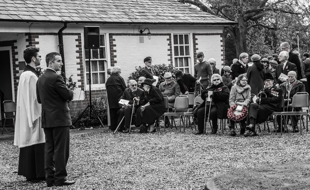 The congregation seated outside the memorial building on Remembrance Day