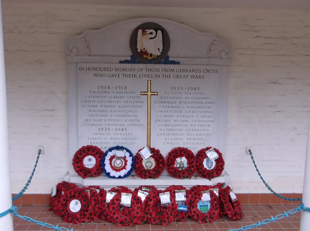 The Roll of Honour listing the Gerrards Cross fallen of both World Wars, with poppy wreaths laid beneath