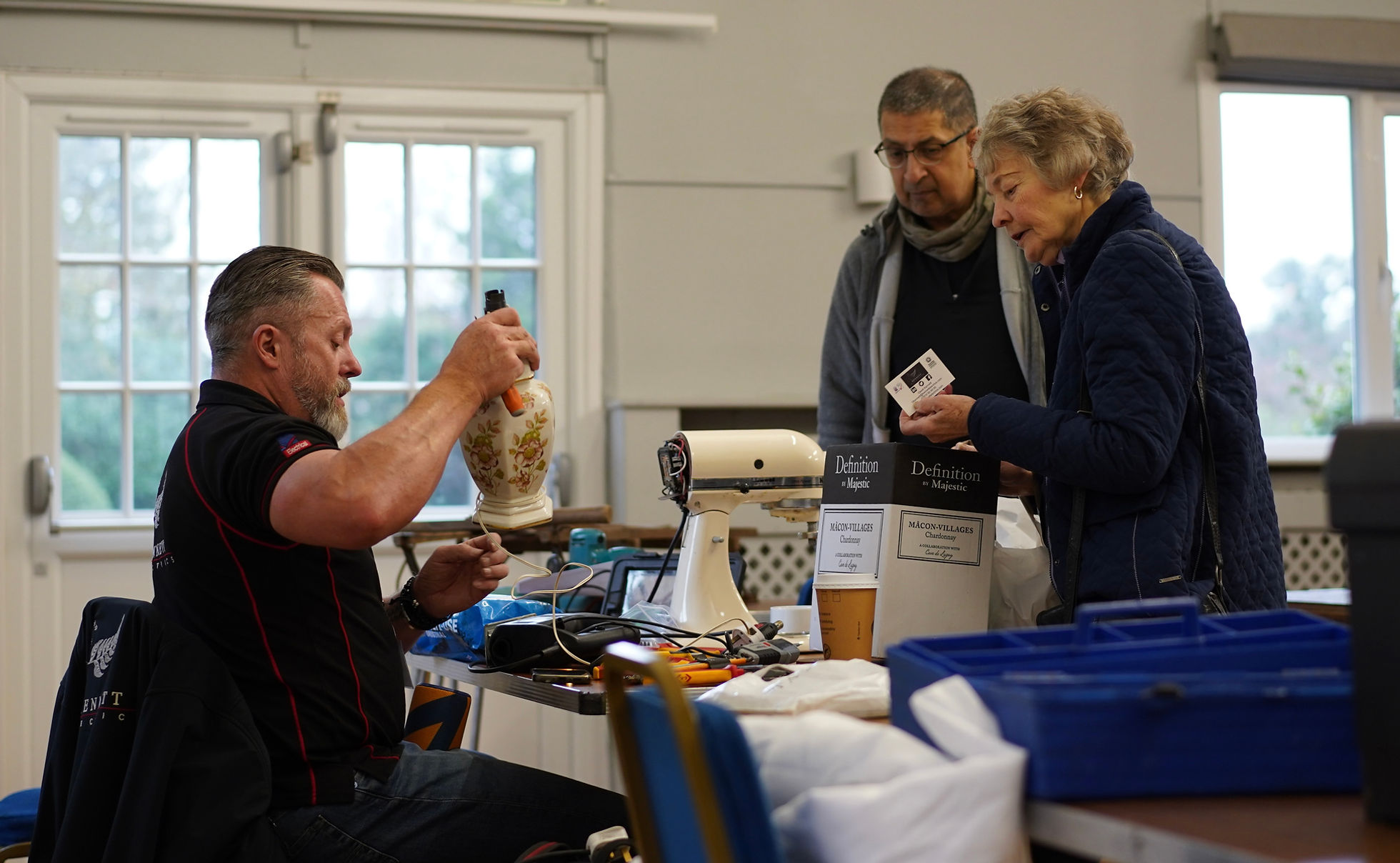 A volunteer repairing an item at the GXCA Repair Café