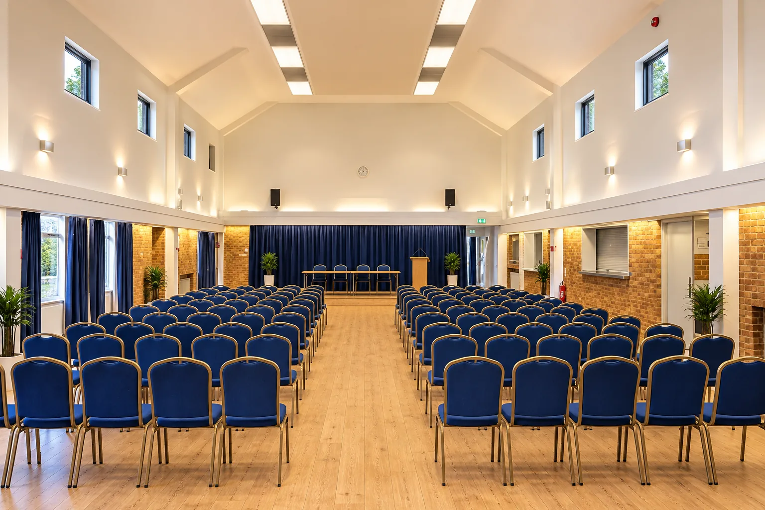 Colston Hall set out theatre-style, rows of blue chairs on either side of a central aisle leading to the stage