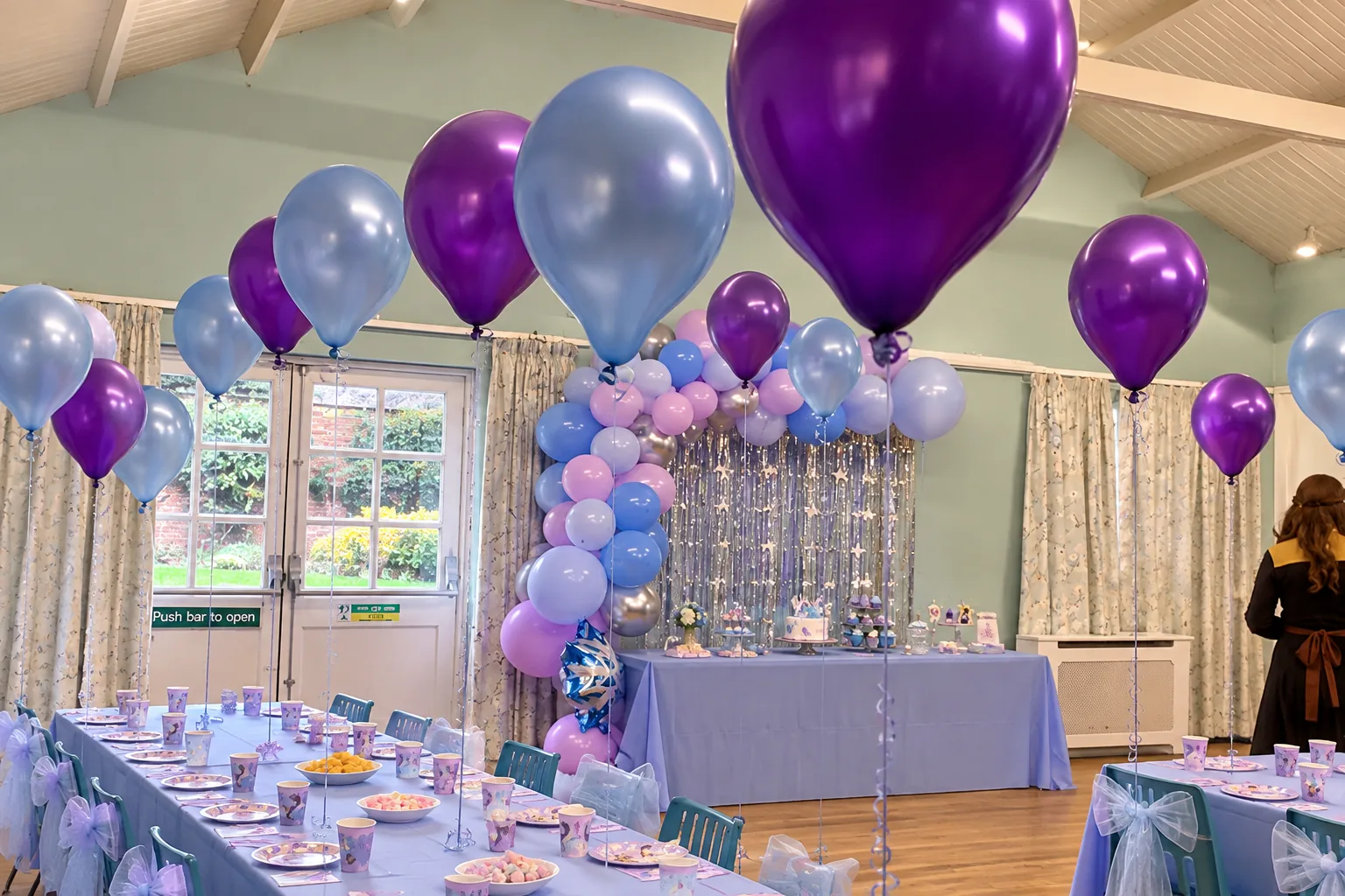 A children’s tea party in the Garden Room with purple and silver balloons