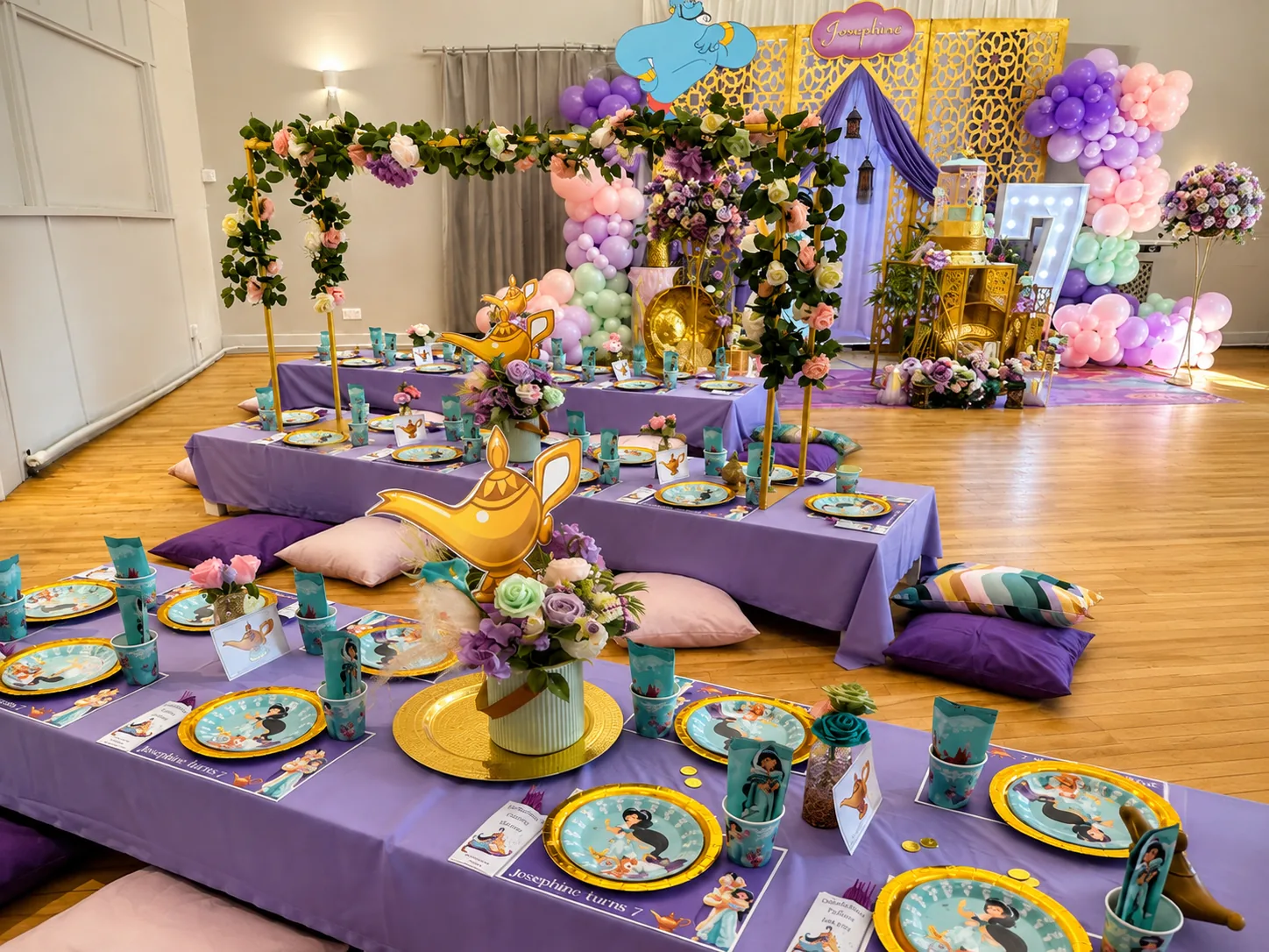 Low tables dressed in purple and gold for a genie-themed party
