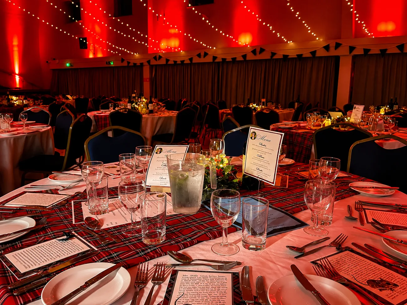 Guests dancing on the floor under coloured party lighting